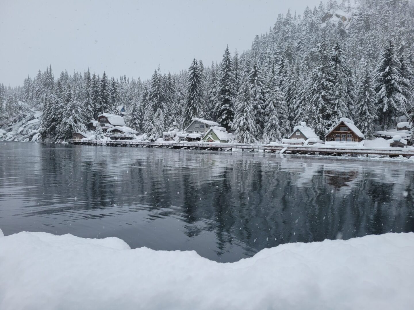 Front view of water lake homes covered with snow