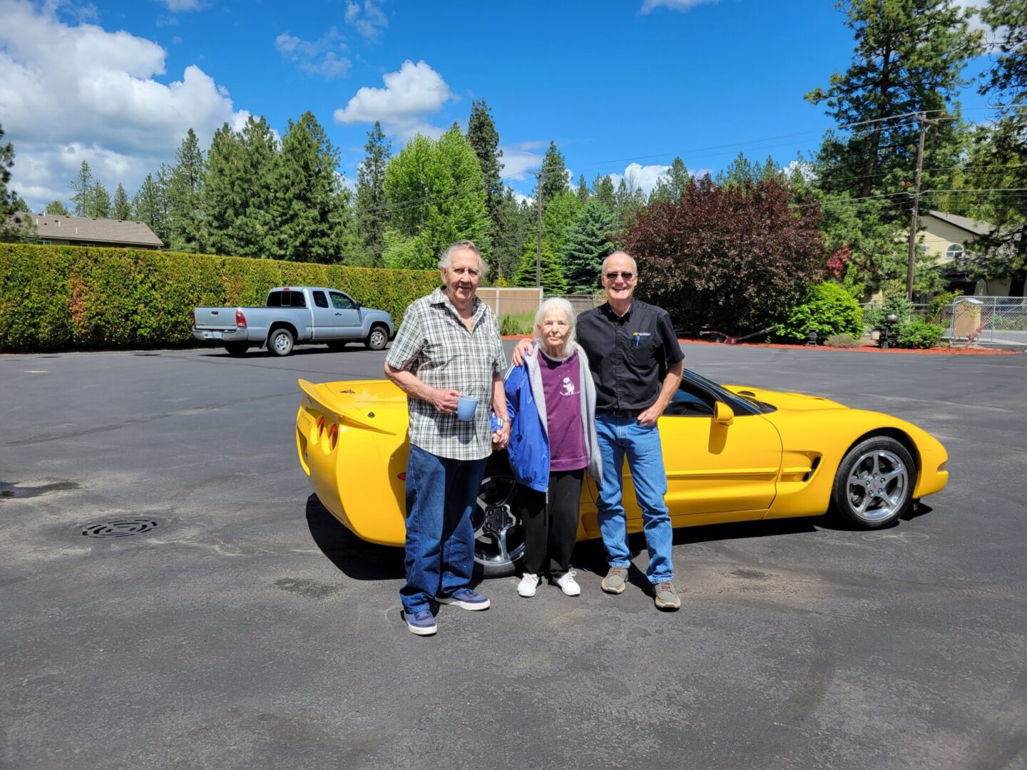 Senior people standing near a sports car