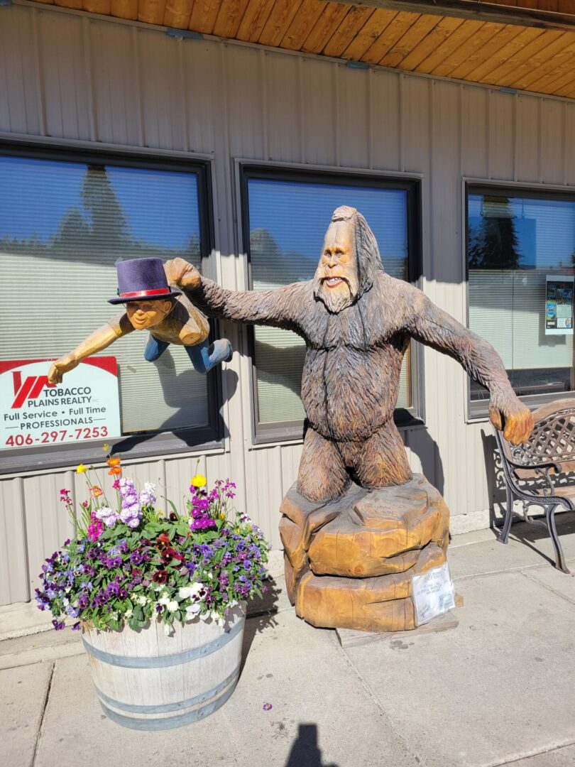 A wooden carved sculpture outside the store