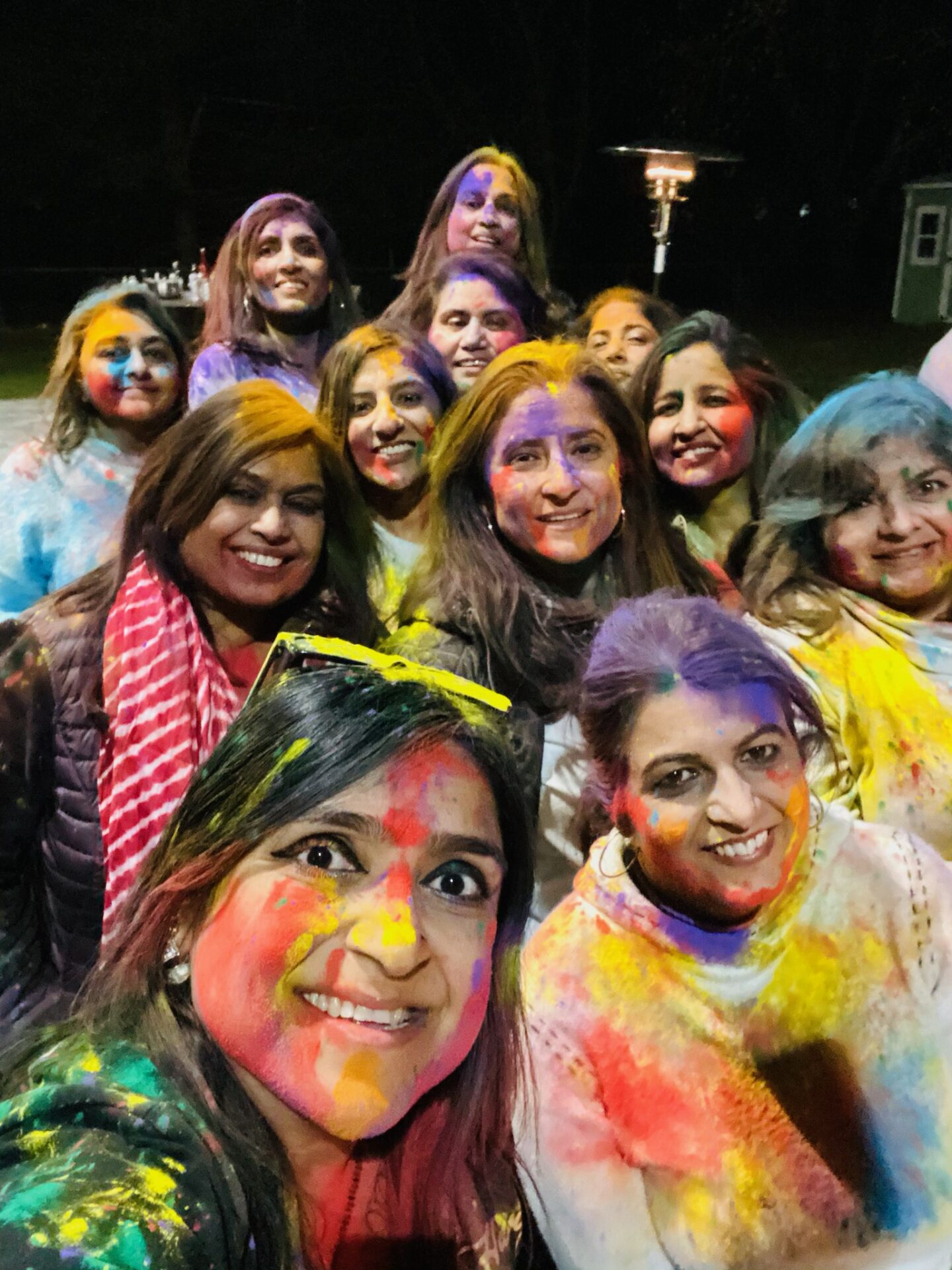 Group of young women covered in colored dye