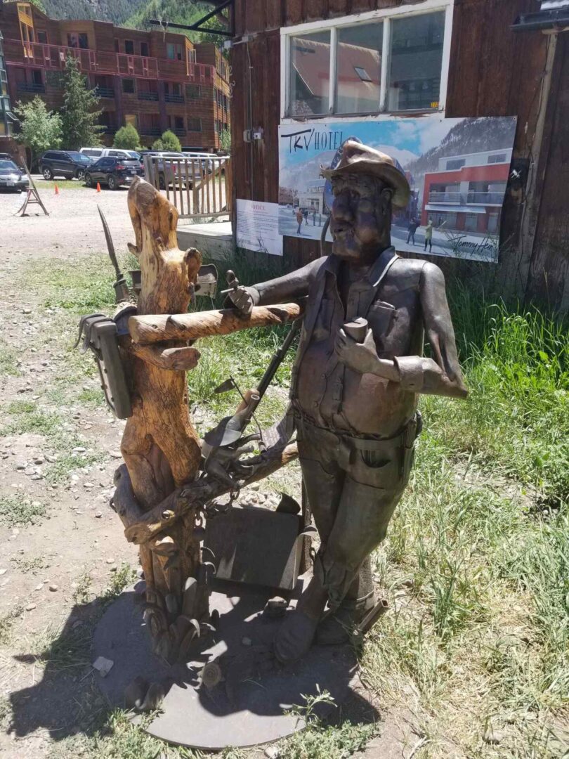 A wooden carved sculpture outside the store